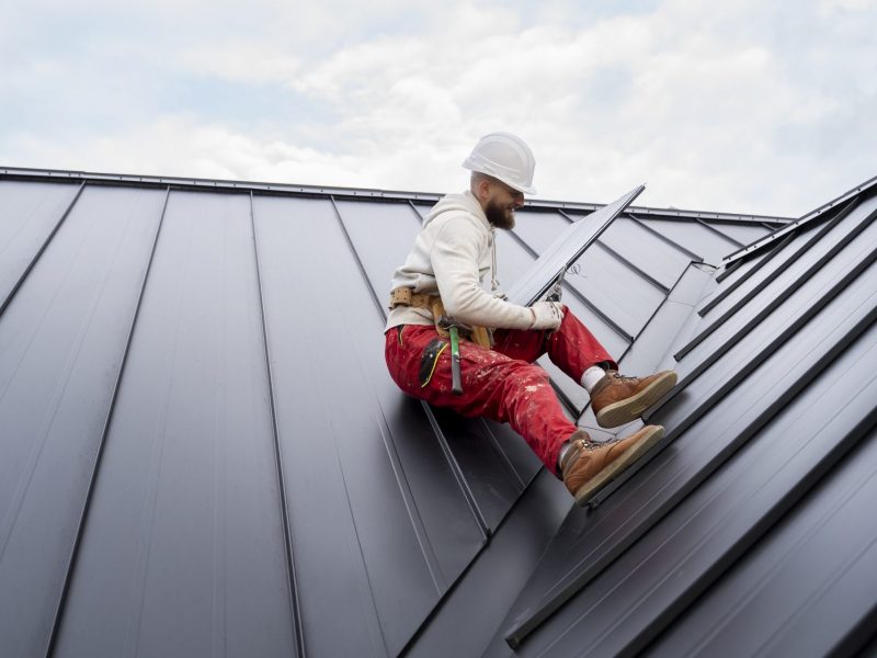 full-shot-man-with-helmet-sitting-roof-scaled-1.jpg